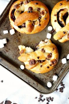 hot cross buns on a baking sheet with marshmallows and chocolate chips