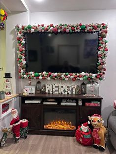 a living room with christmas decorations and a flat screen tv mounted above the fire place