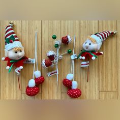 three small christmas ornaments on a wooden floor