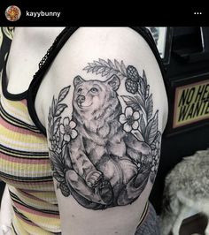 a woman with a bear tattoo on her arm