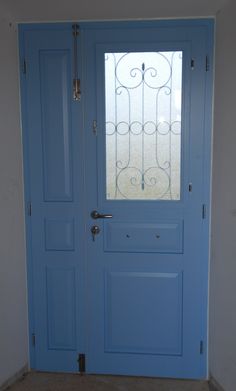 a blue door with a glass window in the center and side panels on both sides