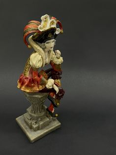 a figurine sitting on top of a pedestal