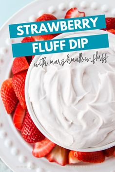 strawberry fluff dip with marshmallow flakes on a white platter, topped with fresh strawberries