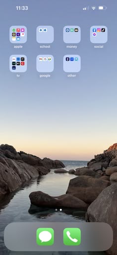 an iphone screen with several different icons on the phone and in the background there is a body of water