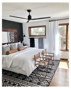 a bedroom with a bed, chair and rug in it's centerpieces