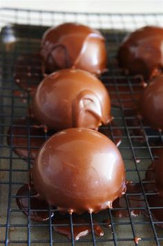 chocolate covered donuts cooling on a wire rack