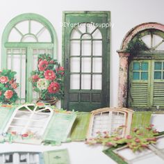 an assortment of miniature windows and shutters are displayed on a white surface with pink flowers