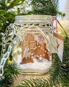 a gingerbread house in a glass jar