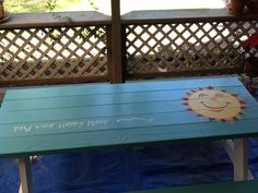 a bench that has been painted to look like a happy place with a sun on it