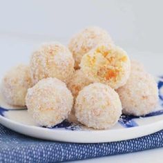 some sugar coated doughnuts are on a blue and white plate next to a napkin