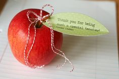 an apple with a note attached to it