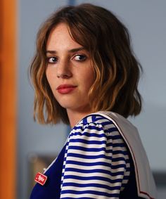 a close up of a person wearing a blue and white shirt