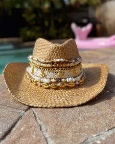 This is for a CUSTOM, MADE TO ORDER piece!  Please message me with your style ideas before you place your order!  Thank you!  Introducing our bespoke Custom Coastal Cowgirl Cowboy Hat, where the charm of the West meets the allure of the coast in a personalized masterpiece. Handcrafted to order, this straw cowboy hat is a celebration of individuality and style, designed to reflect your unique personality and love for coastal living. Adorned with multiple bands of seashell beads in varying sizes a Adjustable Gold Hat Band For Beach, Gold Bohemian Hat For Vacation, Gold Beach Hat, One Size Fits Most, White Handmade Beach Hats, White Handmade Hats For Beach Season, White Handmade Hat For Beach Season, Handmade White Hats For Beach Season, Handmade White Hat Bands For Beach, Beaded Beach Hat One Size Fits Most