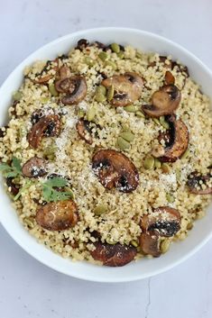 a white bowl filled with rice and mushrooms