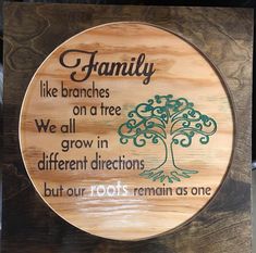 a wooden plaque that says family like branches on a tree we all grow in different directions but our roots remain as one