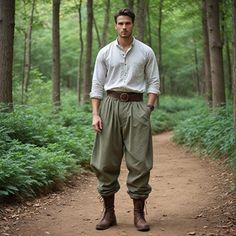 a man standing in the middle of a forest wearing green pants and brown belted boots