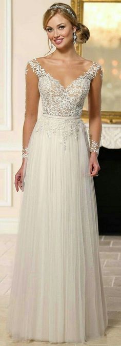 a woman in a long white dress posing for the camera with her hand on her hip