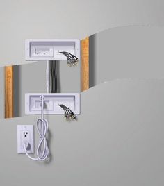 an electrical outlet with two wires attached to the wall and one plugged into it