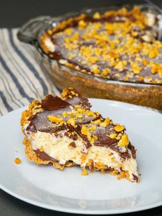 a piece of cake sitting on top of a white plate next to a pie dish