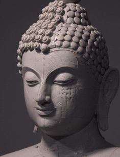 a white buddha statue with its eyes closed