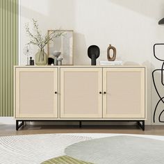 a living room with a white cabinet and green wall