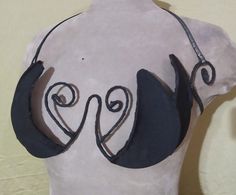 a white mannequin with black hair and mustaches on it