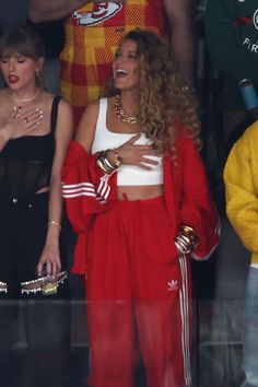 two women in red and white outfits standing next to each other