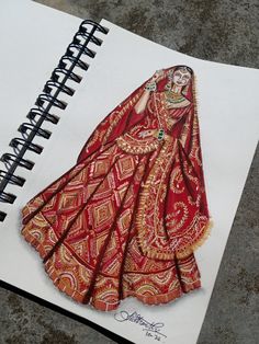 a drawing of a woman in a red and gold dress on a spiral notebook with writing underneath