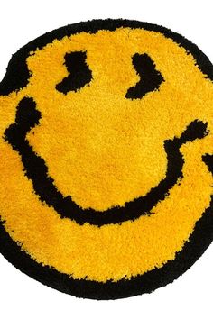 a yellow and black smiley face rug on a white background with the words happy written across it