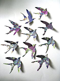 a group of paper birds that are flying in the air