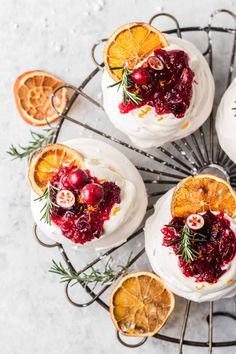 small cakes with cranberry sauce and orange slices on a wire rack