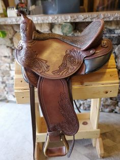 a saddle sitting on top of a wooden table