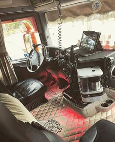 the interior of a vehicle with leather seats and electronic gadgets on the dash board