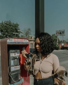 a woman standing next to a parking meter