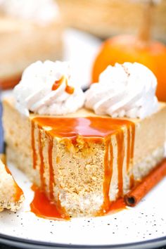 a slice of cheesecake with caramel sauce and whipped cream is on a plate