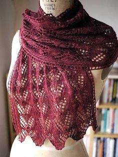 a red shawl on top of a mannequin