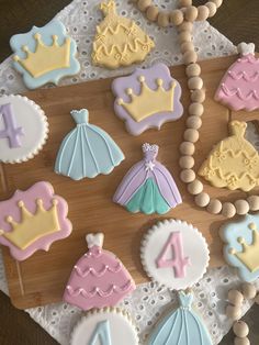 some decorated cookies are on a wooden board