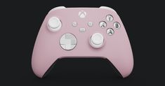 a close up of a pink controller on a black background