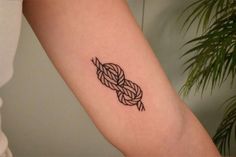 a tattoo on the arm of a woman with a knot in it's middle