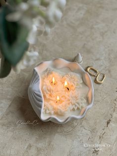 a small white bowl with some candles in it