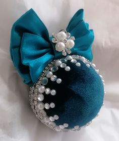 an ornament with pearls and a bow on it