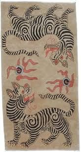 an animal rug with zebras and other animals on it's back side, in beige