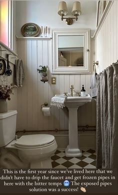 a bathroom with a checkered floor and white walls, has a quote about it