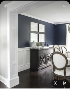 an empty dining room with blue walls and white trim on the walls is shown in this image