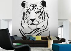 a living room with a tiger wall decal on the wall next to a couch