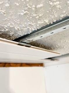 the ceiling is covered with white paint and silver flecks on it's surface