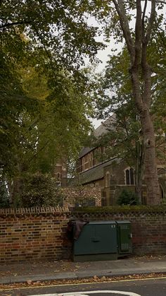 a street corner with a brick wall and trees