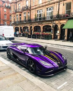 a purple sports car is parked on the street