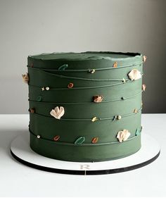 a green cake sitting on top of a white plate