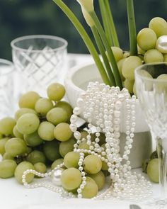 grapes and pearls are arranged on a table